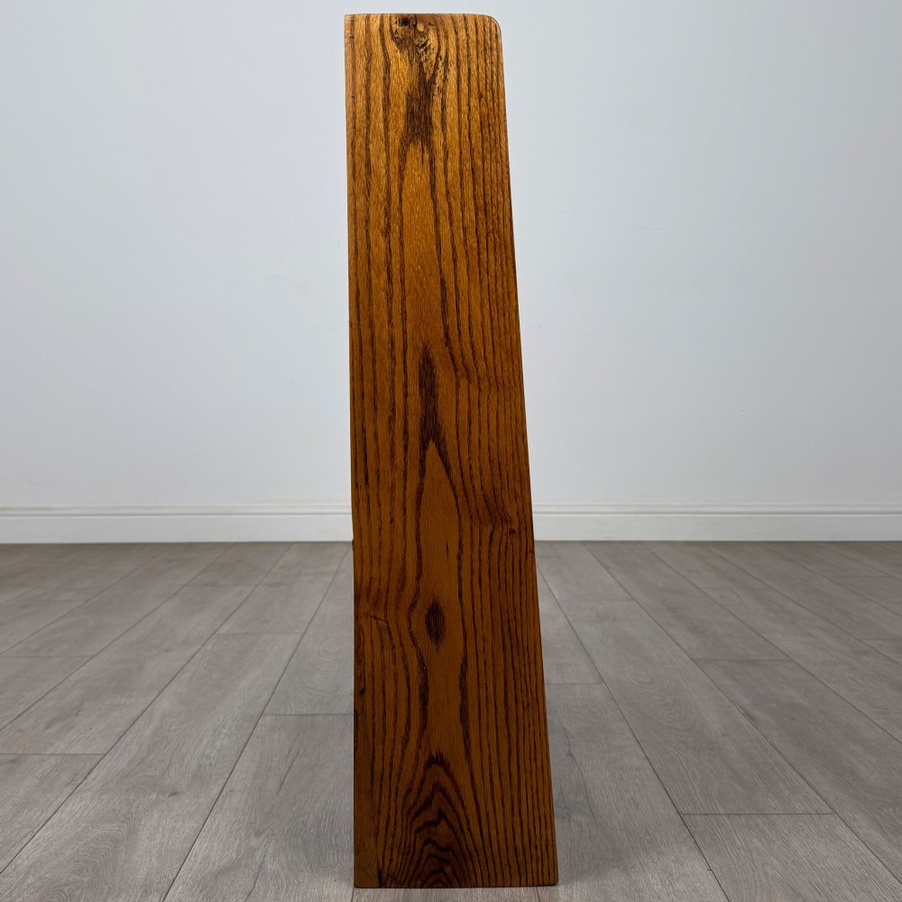 An open golden oak bookcase featuring four horizontal shelves arranged vertically with solid side panels. View VIII