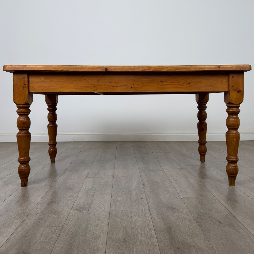A solid pine farmhouse dining table featuring four turned legs and a single side frieze drawer with a wooden knob handle. View II