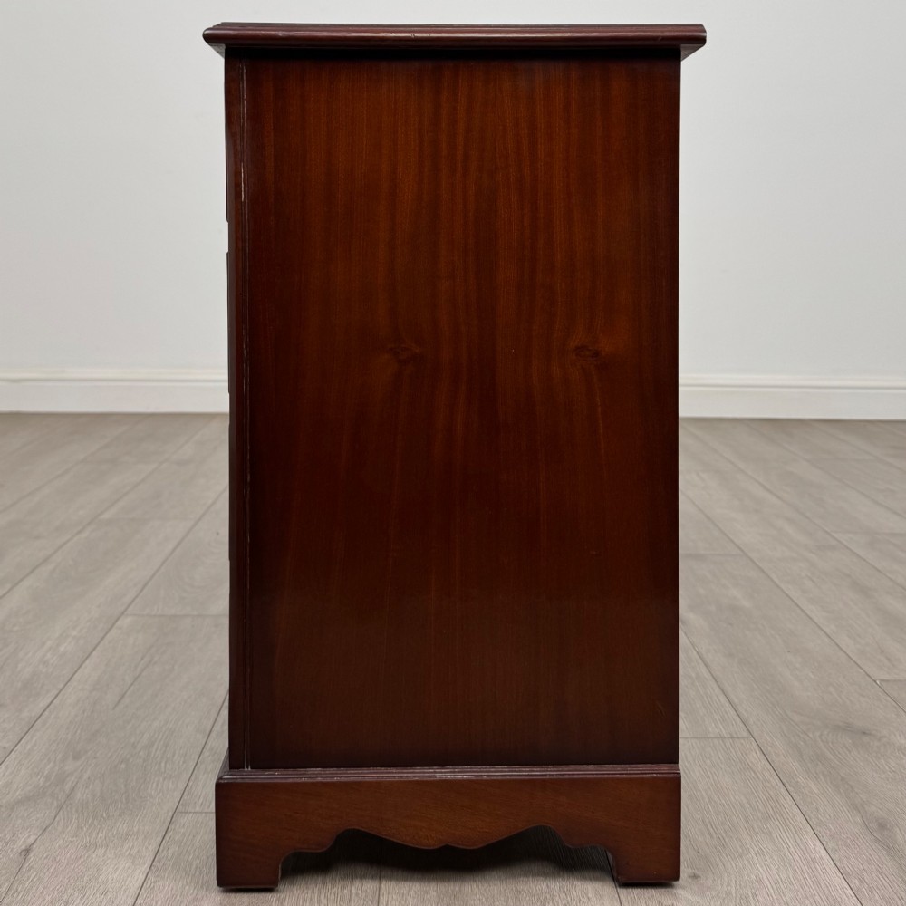 A 20th-century inlaid mahogany chest of drawers featuring two short over three long drawers with decorative brass handles. View III