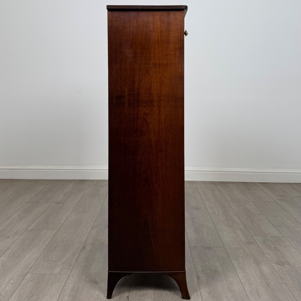A tall 19th-century Regency mahogany open bookcase featuring four open shelves, a top drawer with twin brass knobs, and flared feet. View VIII