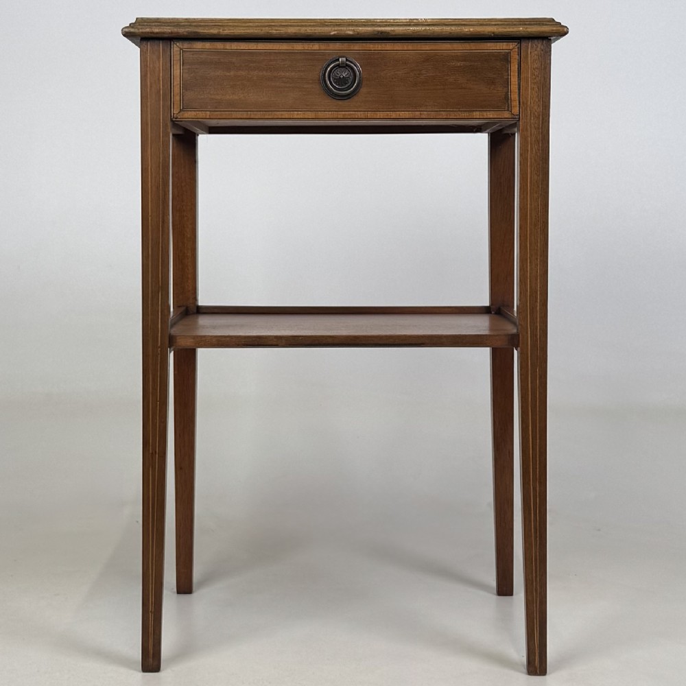 A pair of tall, slim mahogany bedside tables with single top drawers, round brass ring handles, open lower shelves, and tapered legs. View II