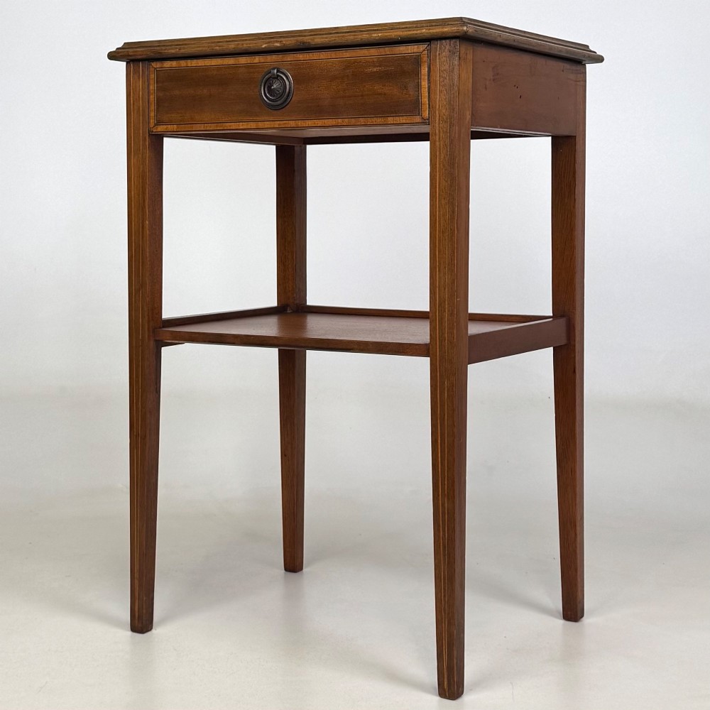 A pair of tall, slim mahogany bedside tables with single top drawers, round brass ring handles, open lower shelves, and tapered legs. View III