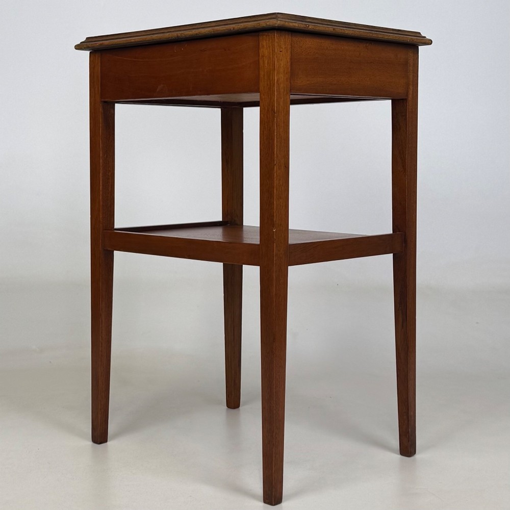 A pair of tall, slim mahogany bedside tables with single top drawers, round brass ring handles, open lower shelves, and tapered legs. View VII