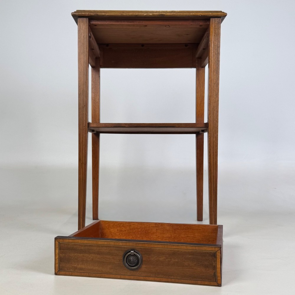 A pair of tall, slim mahogany bedside tables with single top drawers, round brass ring handles, open lower shelves, and tapered legs. View X