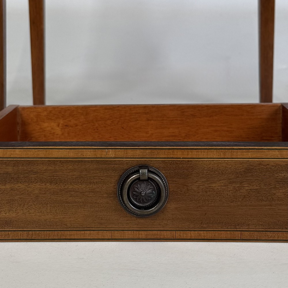A pair of tall, slim mahogany bedside tables with single top drawers, round brass ring handles, open lower shelves, and tapered legs. View XI