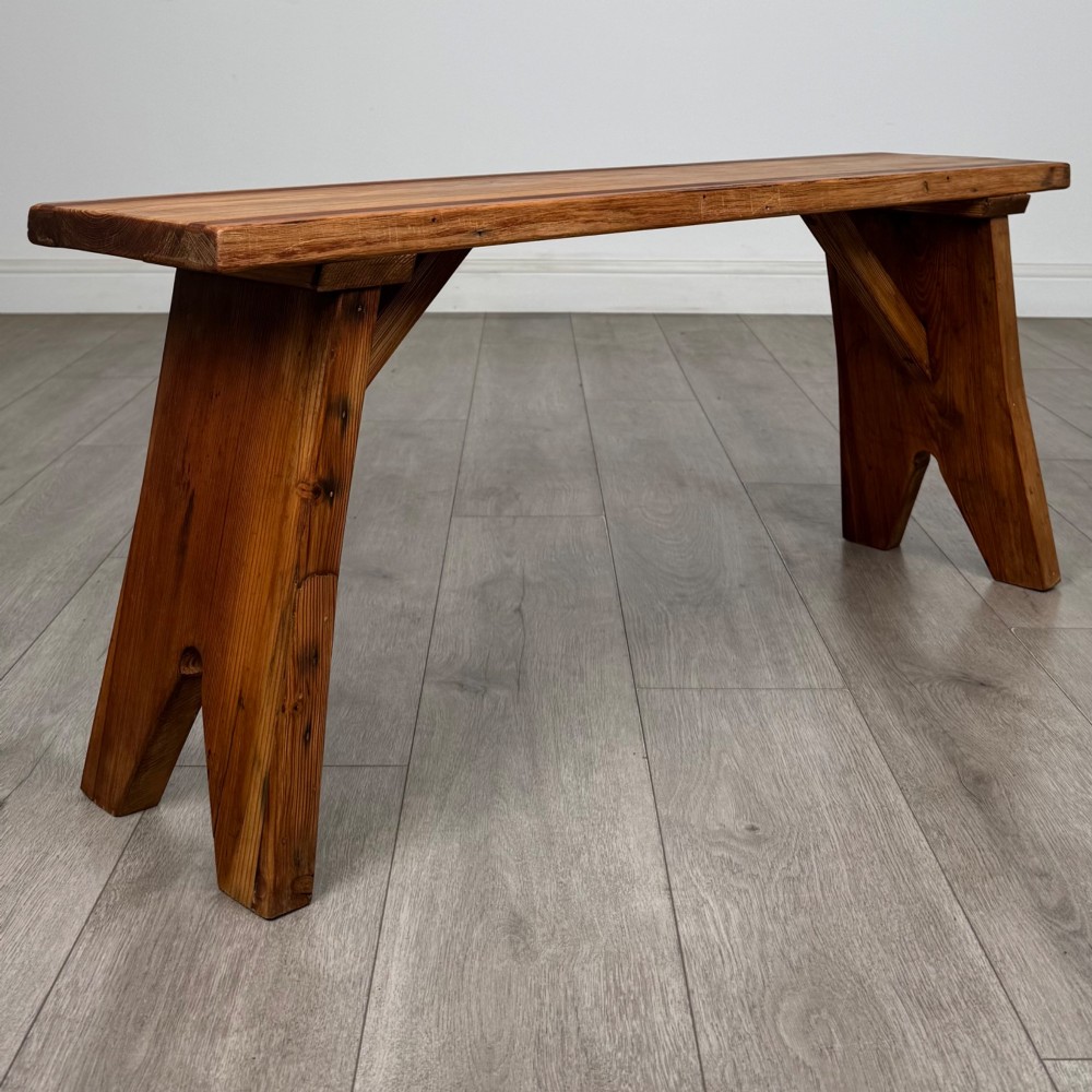 A pitch pine wooden bench with angled trestle legs, diagonal side braces, and a reeded edge along the top rectangular seat. View III