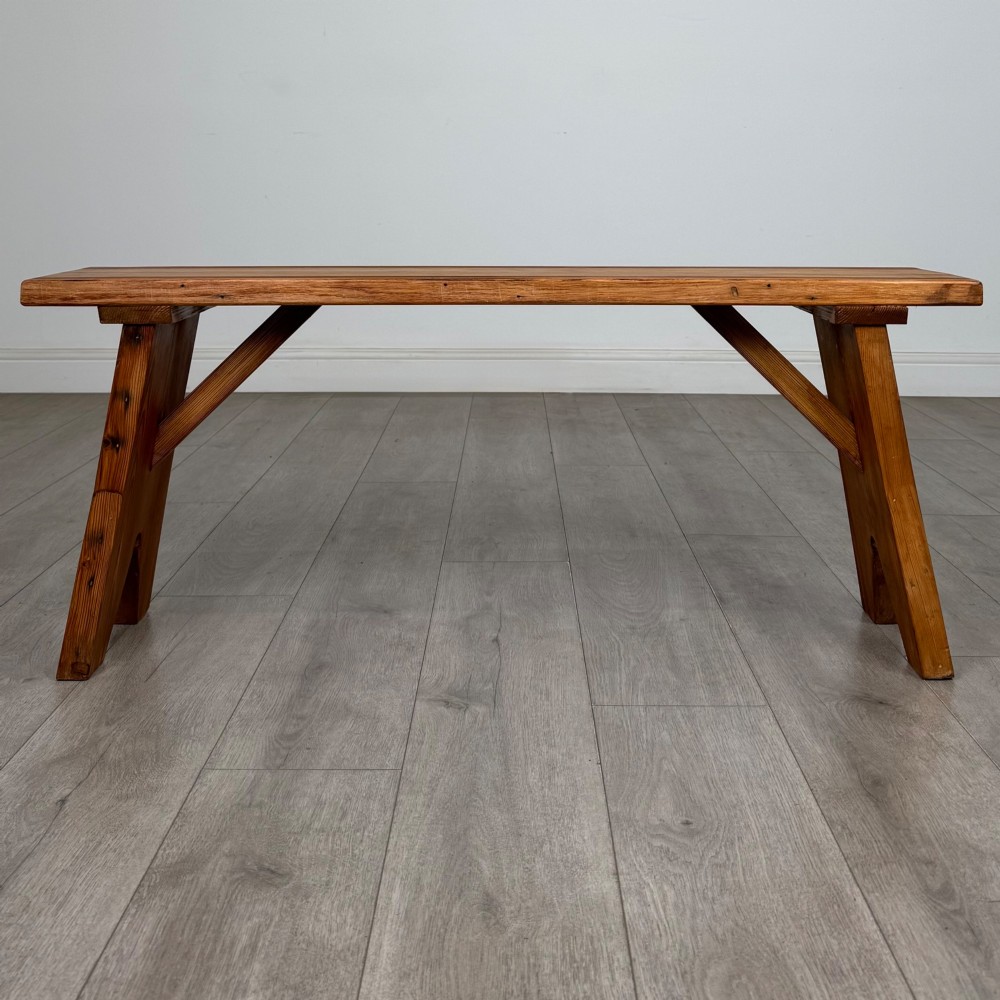 A pitch pine wooden bench with angled trestle legs, diagonal side braces, and a reeded edge along the top rectangular seat. View IV