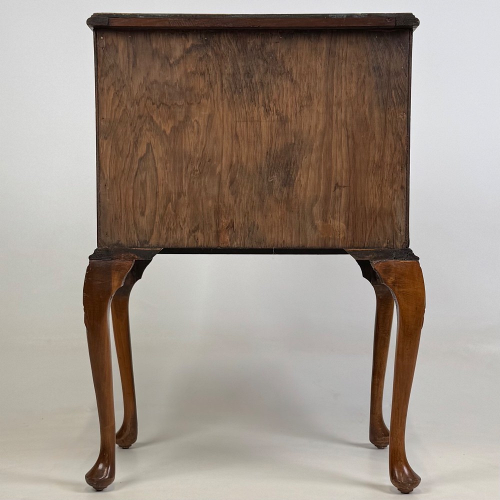 A small 20th-century walnut chest featuring three drawers, brass handles, and tall carved cabriole legs. View V
