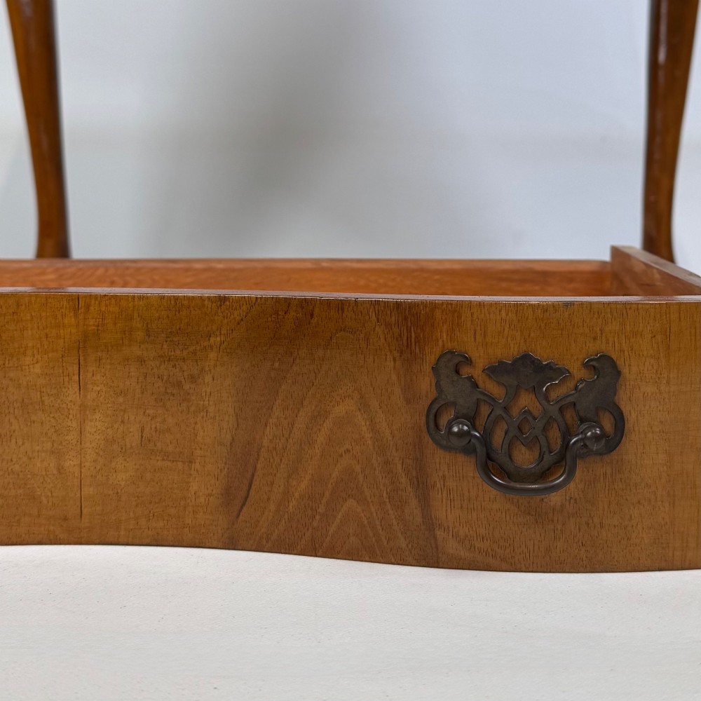 A small 20th-century walnut chest featuring three drawers, brass handles, and tall carved cabriole legs. View XI