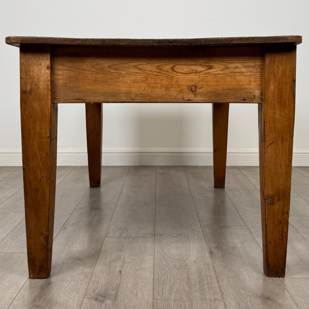 A 19th-century pine writing table featuring two front drawers with brass cup handles and tapered square legs. View III