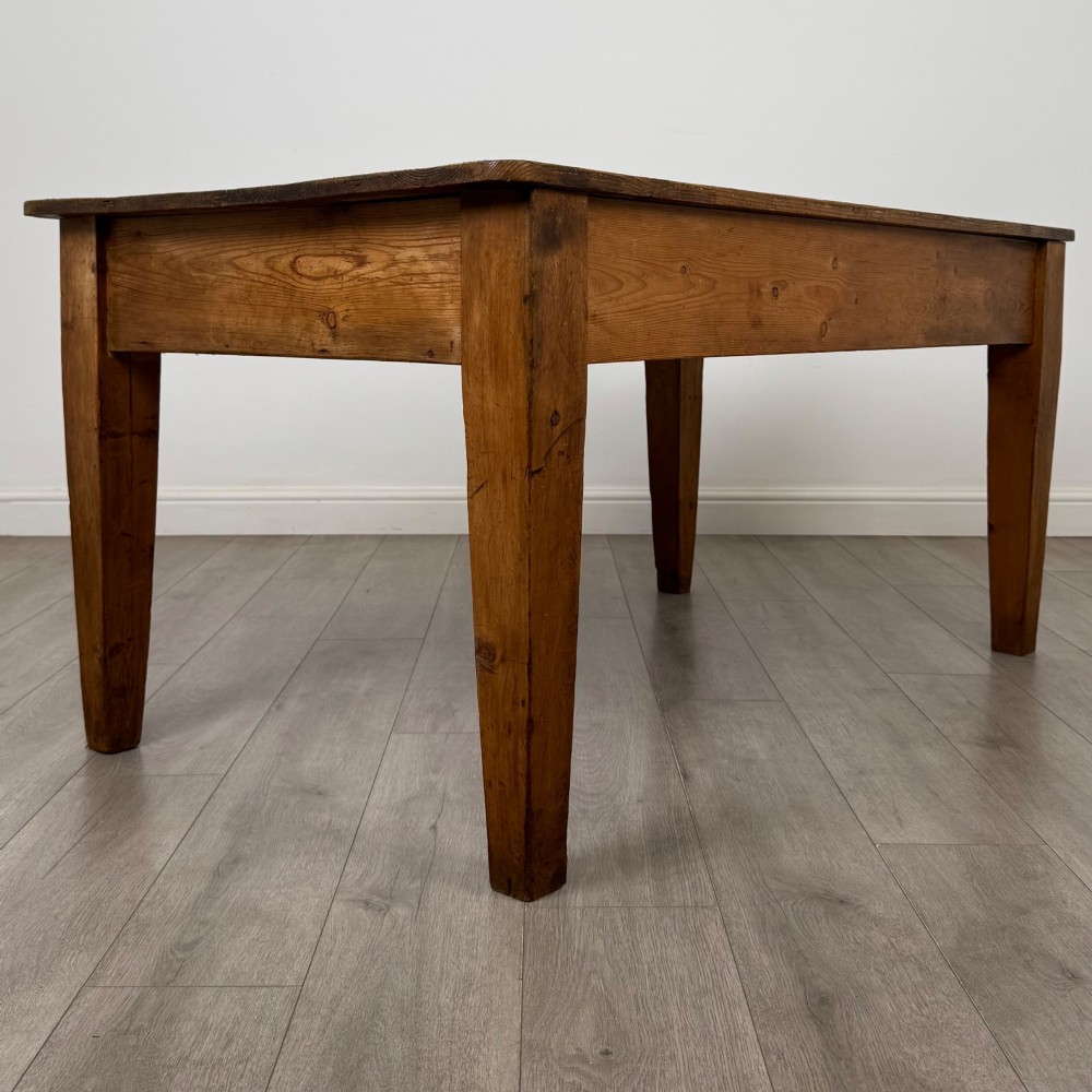 A 19th-century pine writing table featuring two front drawers with brass cup handles and tapered square legs. View IV
