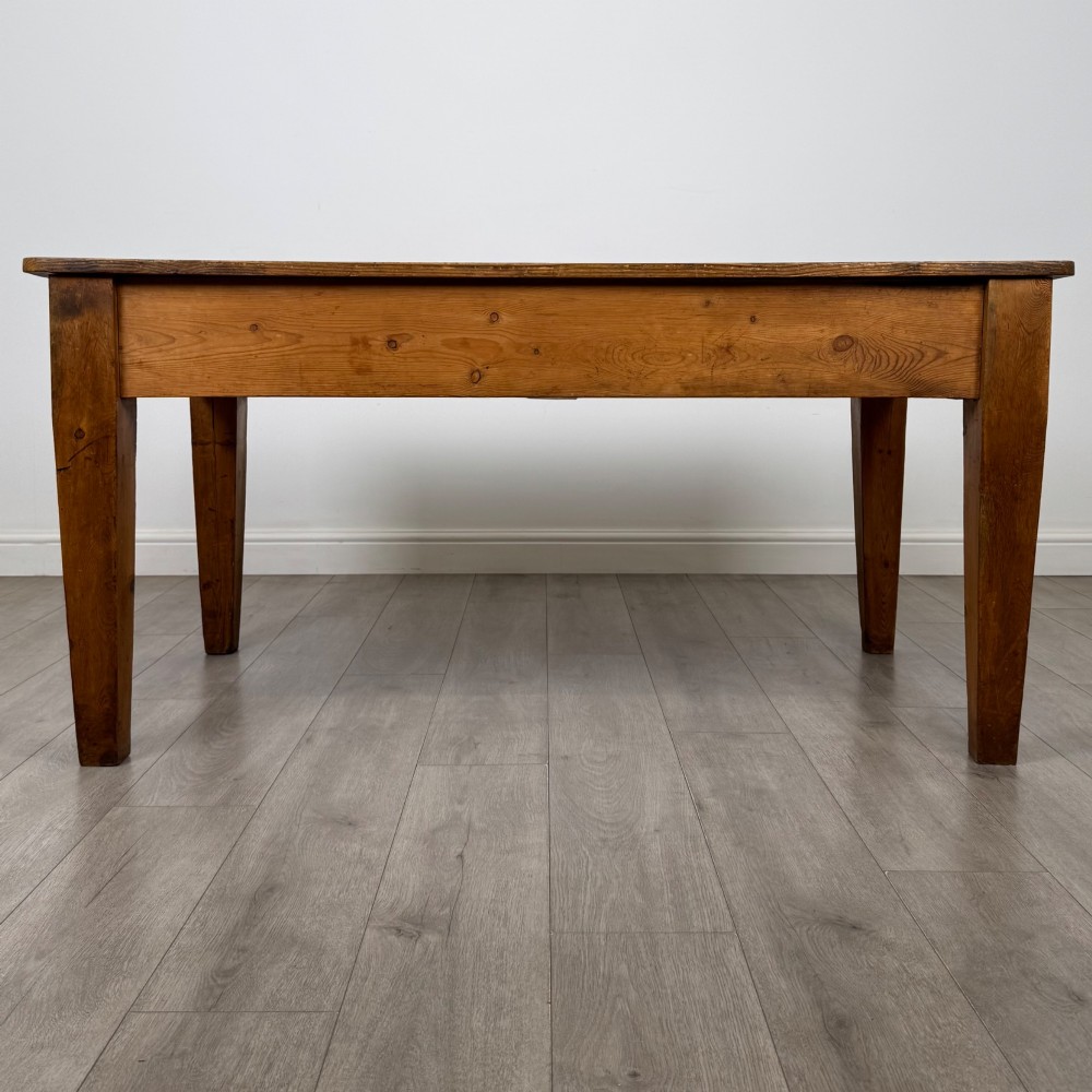 A 19th-century pine writing table featuring two front drawers with brass cup handles and tapered square legs. View V