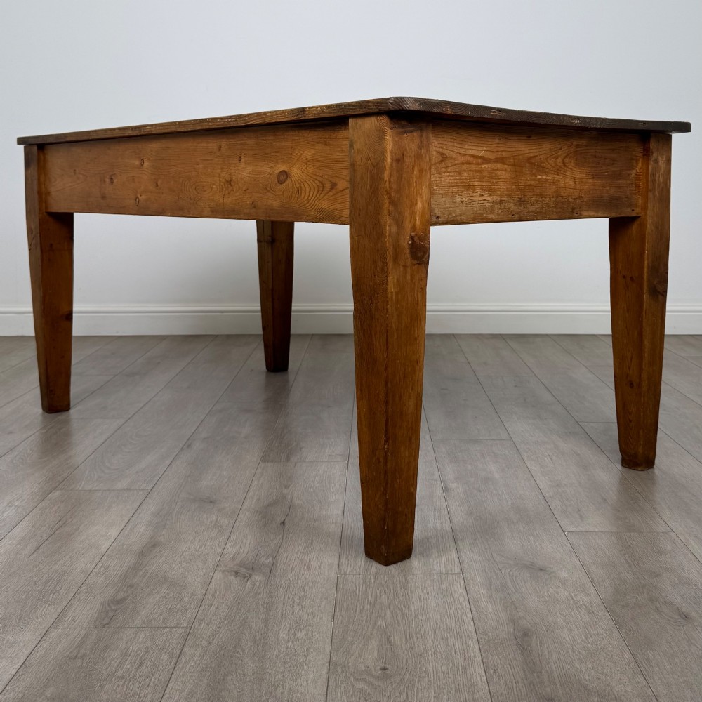 A 19th-century pine writing table featuring two front drawers with brass cup handles and tapered square legs. View VI