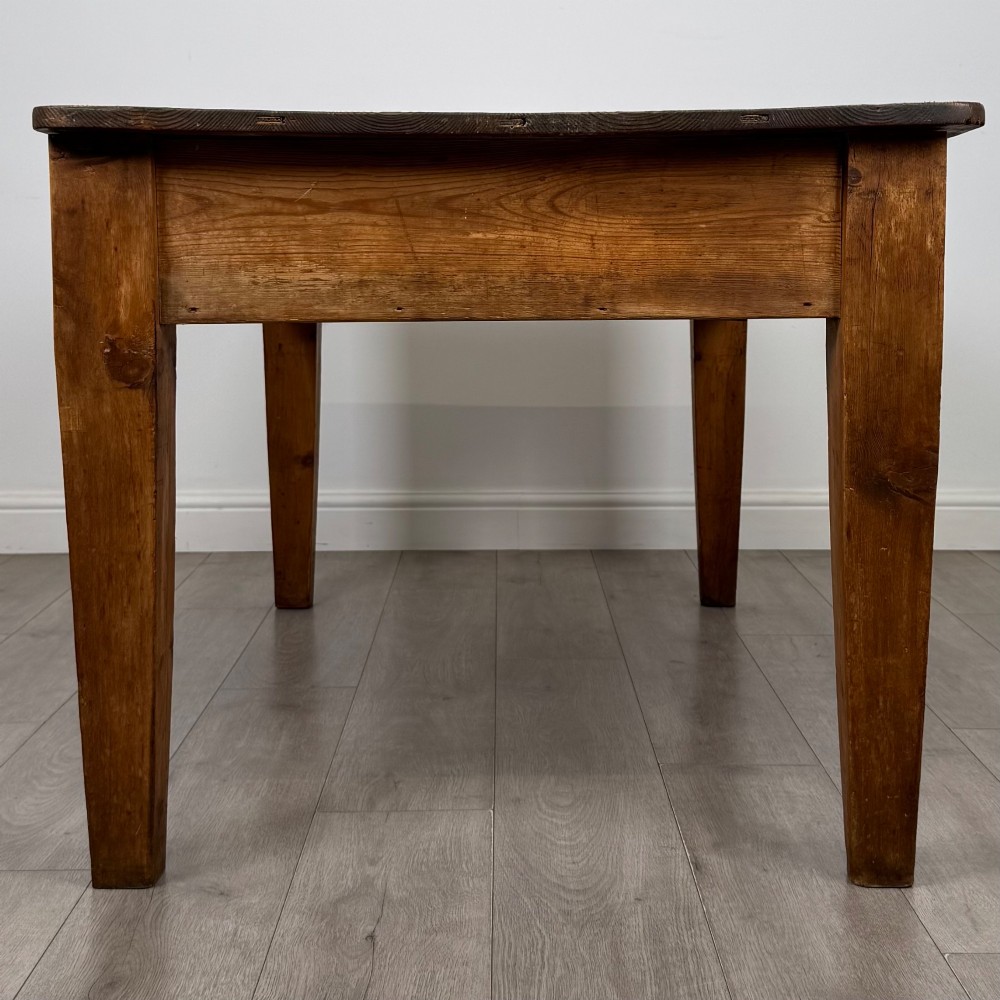 A 19th-century pine writing table featuring two front drawers with brass cup handles and tapered square legs. View VII