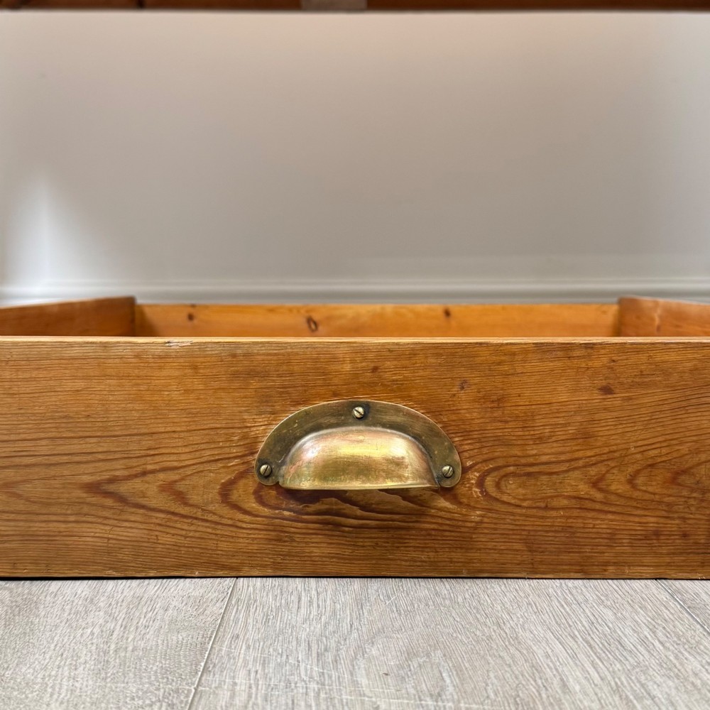 A 19th-century pine writing table featuring two front drawers with brass cup handles and tapered square legs. View XI