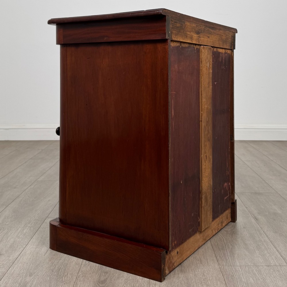 A pair of matching 19th-century Victorian mahogany bedside cabinets with single arched panel doors and plinth bases. View VI