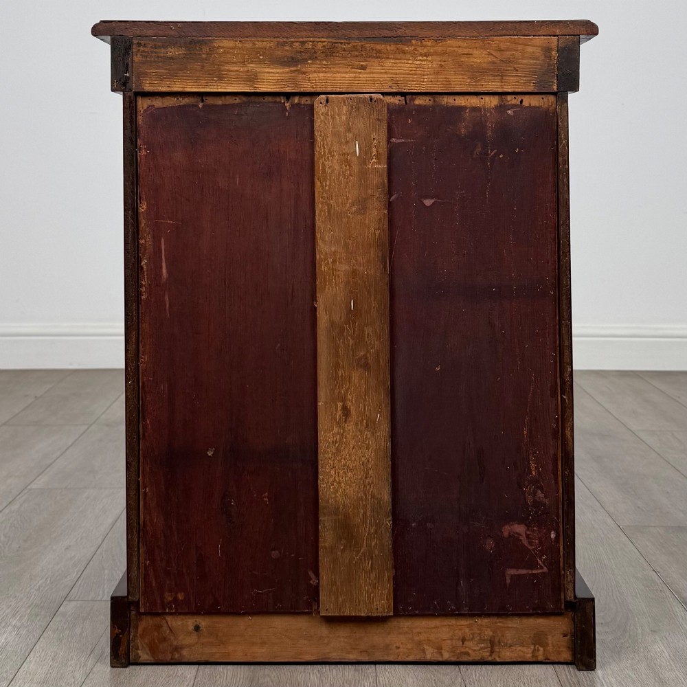 A pair of matching 19th-century Victorian mahogany bedside cabinets with single arched panel doors and plinth bases. View VII