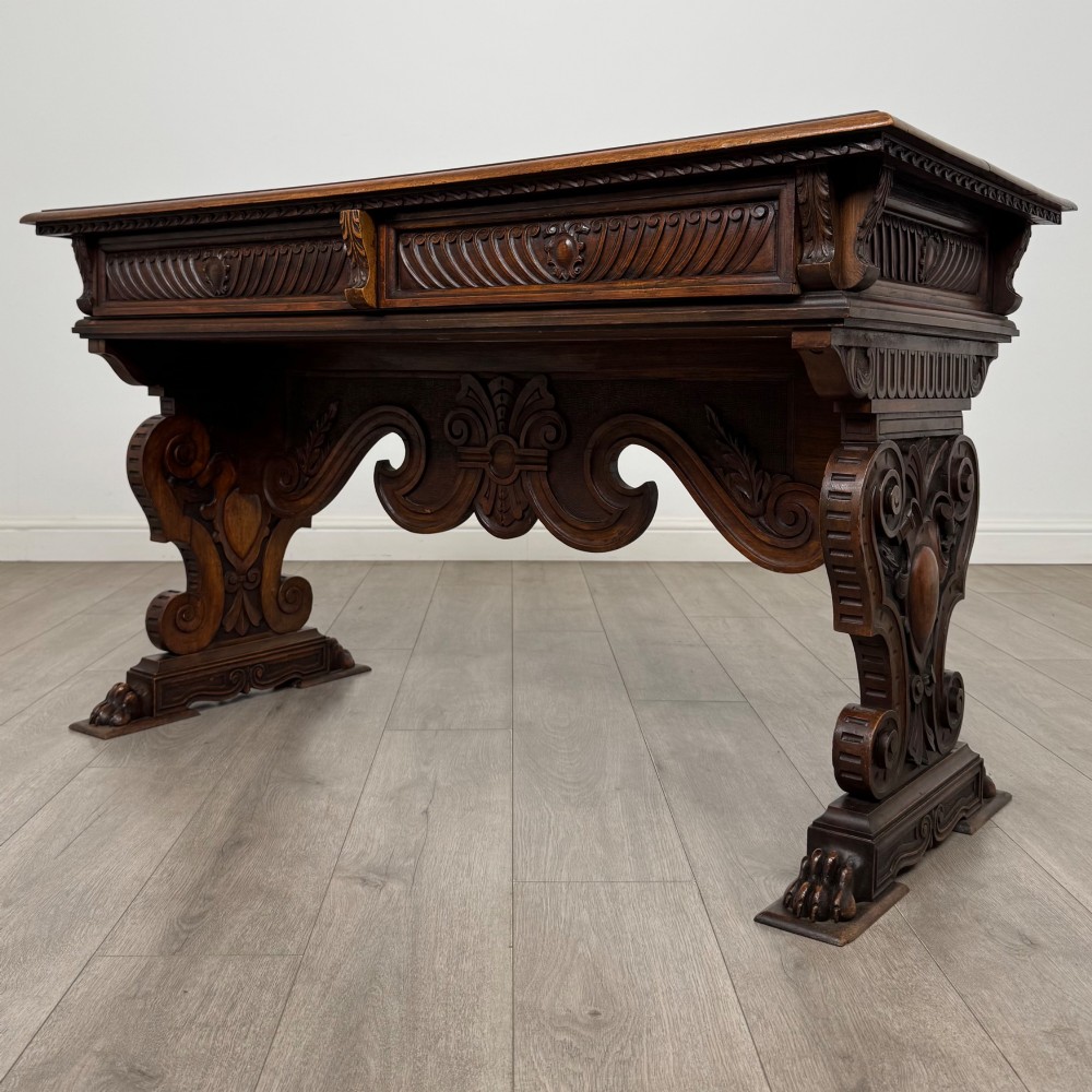 A 19th-century French-style carved walnut side table featuring two decorated drawers, scrolling legs, and paw feet. View II