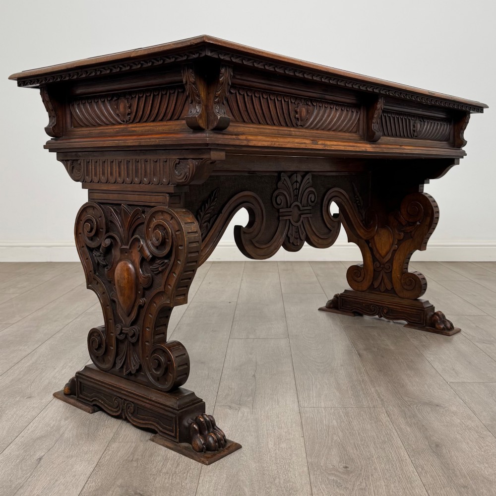 A 19th-century French-style carved walnut side table featuring two decorated drawers, scrolling legs, and paw feet. View IV