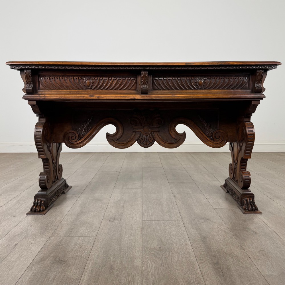 A 19th-century French-style carved walnut side table featuring two decorated drawers, scrolling legs, and paw feet. View V