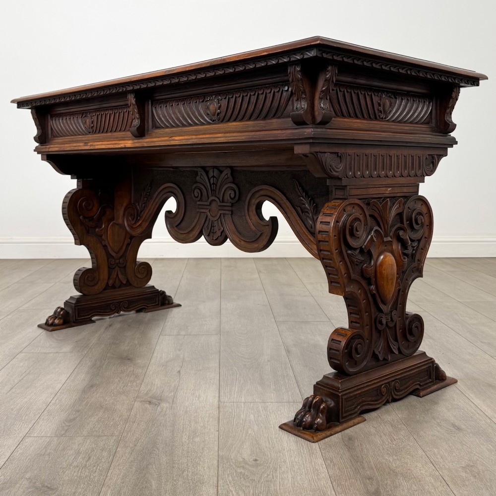 A 19th-century French-style carved walnut side table featuring two decorated drawers, scrolling legs, and paw feet. View VI