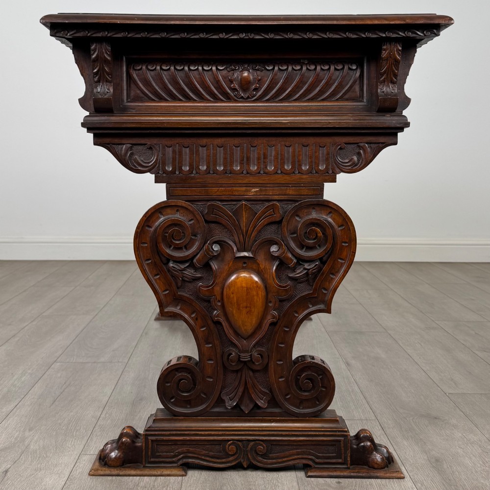 A 19th-century French-style carved walnut side table featuring two decorated drawers, scrolling legs, and paw feet. View VII