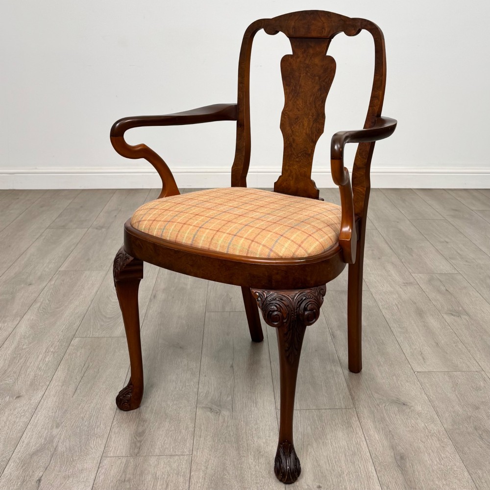 A set of eight Queen Anne revival burr walnut dining chairs featuring carved cabriole legs, claw and ball feet, vasiform splat backs, and patterned upholstered seats. View II