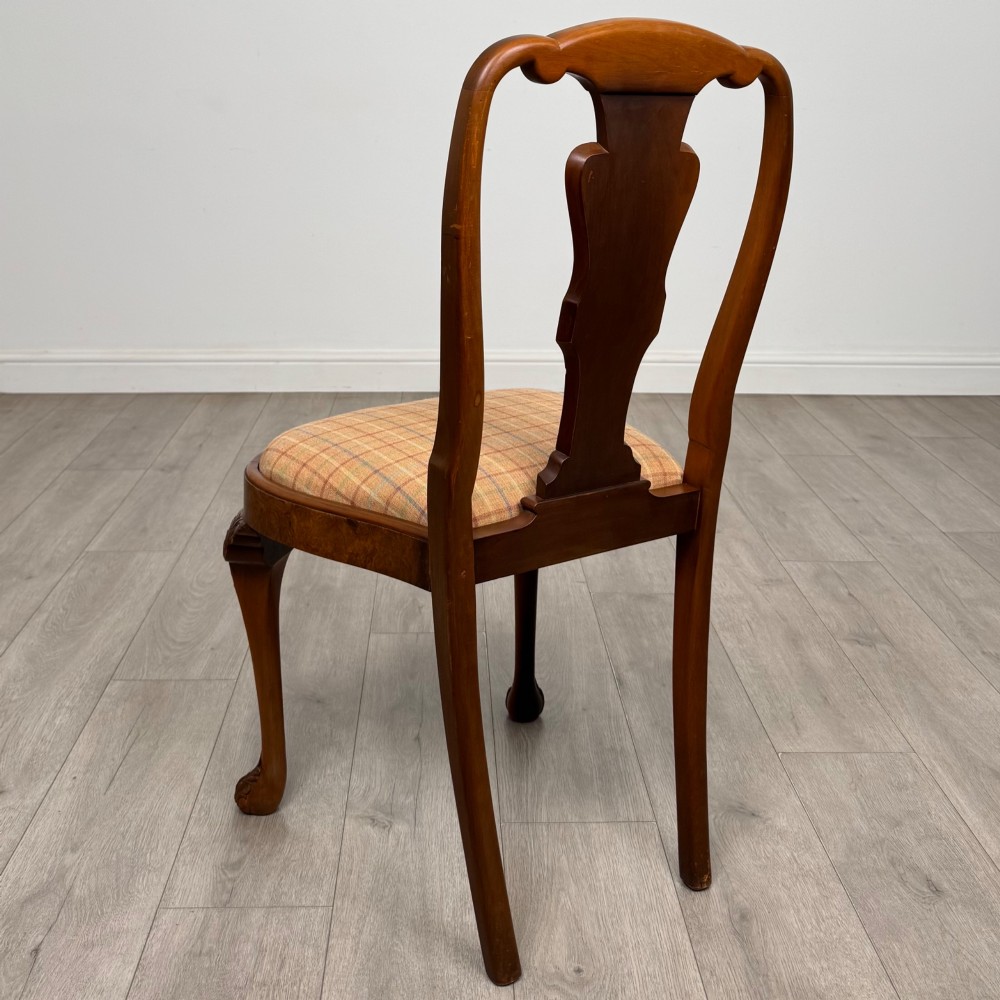 A set of eight Queen Anne revival burr walnut dining chairs featuring carved cabriole legs, claw and ball feet, vasiform splat backs, and patterned upholstered seats. View IV