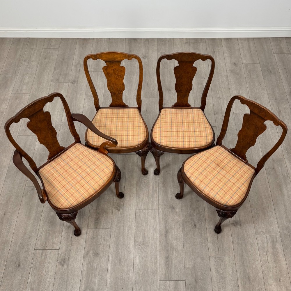 A set of eight Queen Anne revival burr walnut dining chairs featuring carved cabriole legs, claw and ball feet, vasiform splat backs, and patterned upholstered seats. View VIII