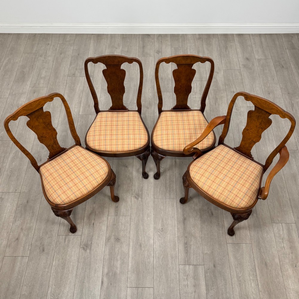 A set of eight Queen Anne revival burr walnut dining chairs featuring carved cabriole legs, claw and ball feet, vasiform splat backs, and patterned upholstered seats. View IX