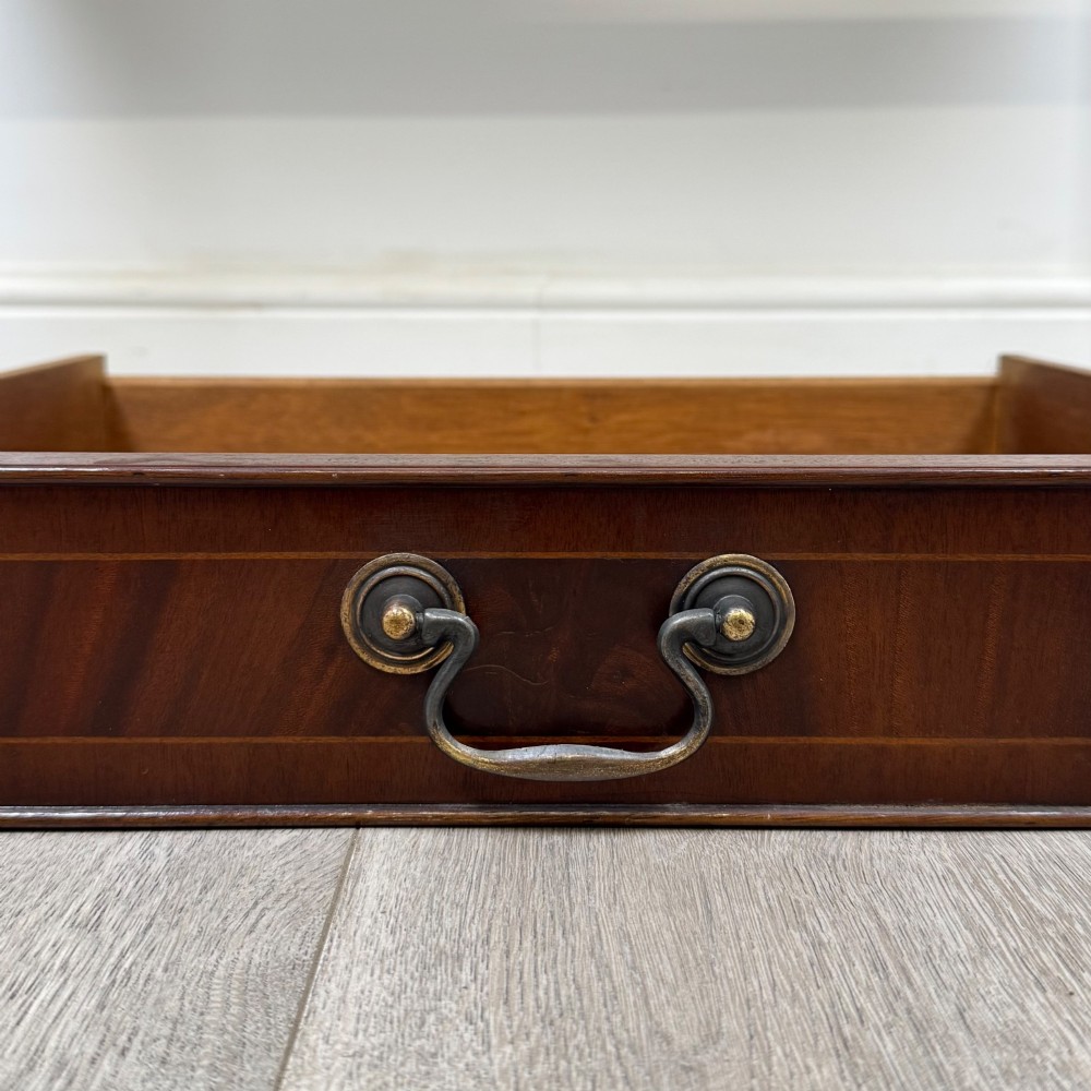 A dark mahogany writing table featuring two frieze drawers with brass swan-neck handles and tapered square legs. View XI