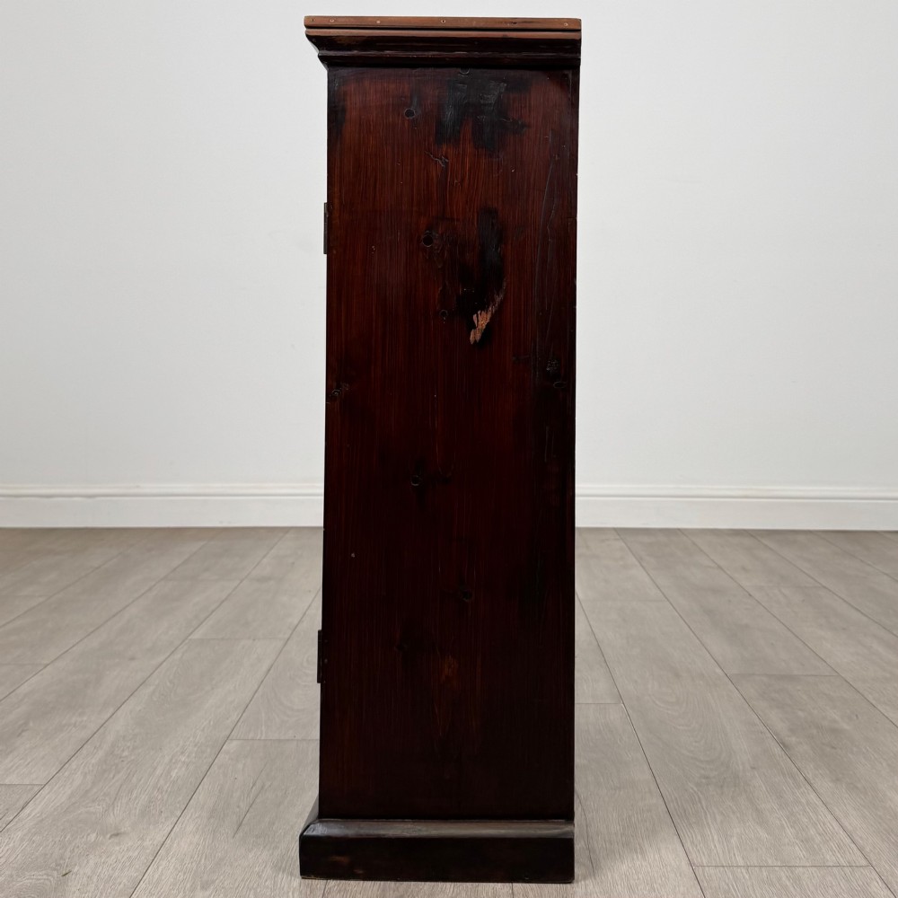 A dark brown stained Edwardian pine glazed cabinet featuring a single glass door with a turned wooden handle and internal shelves. View IV
