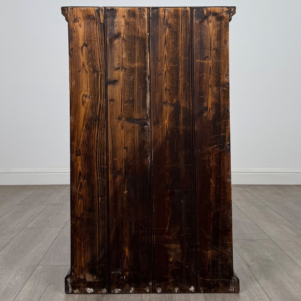 A dark brown stained Edwardian pine glazed cabinet featuring a single glass door with a turned wooden handle and internal shelves. View VI