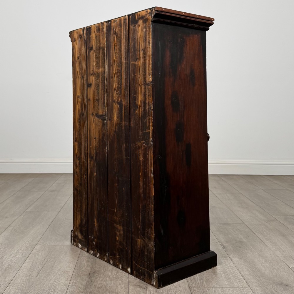 A dark brown stained Edwardian pine glazed cabinet featuring a single glass door with a turned wooden handle and internal shelves. View VII
