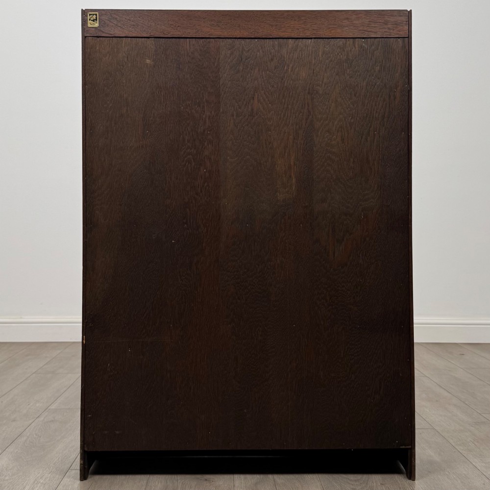 An antique dark oak open bookcase featuring four horizontal shelves with raised side galleries and a solid plinth base. View VI