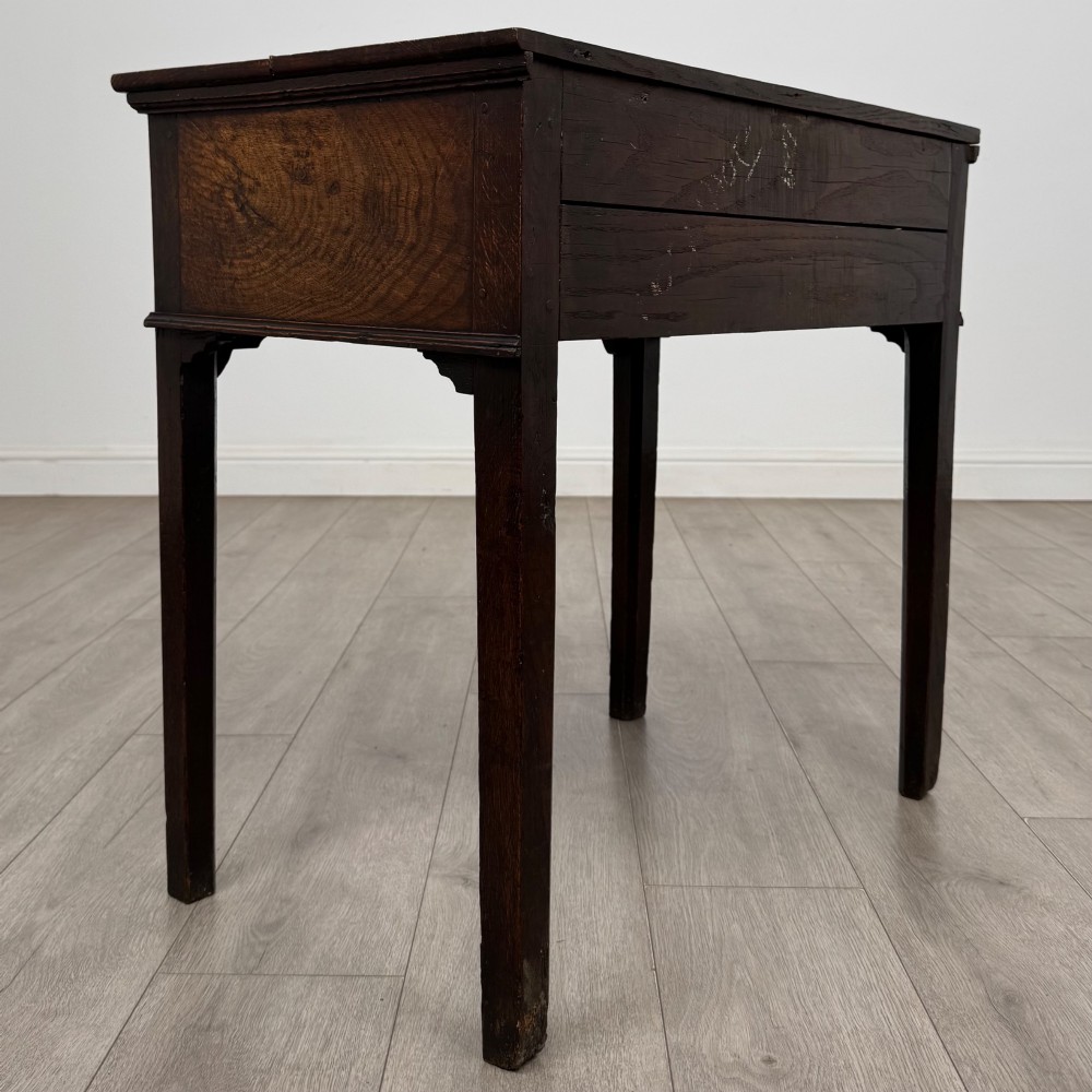 An 18th-century Georgian oak side table featuring a single frieze drawer with brass handles and straight square legs. View IV