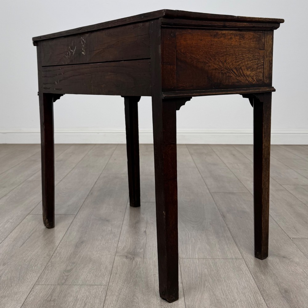 An 18th-century Georgian oak side table featuring a single frieze drawer with brass handles and straight square legs. View VI