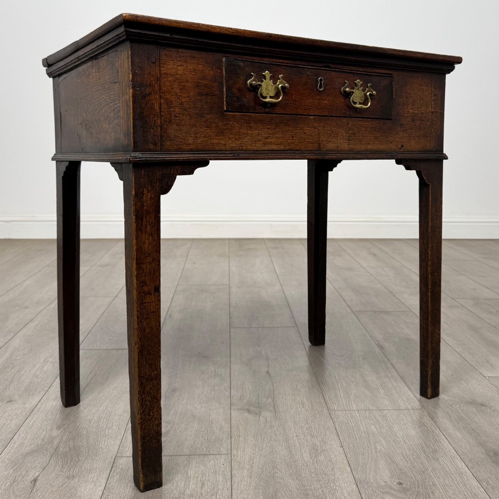 An 18th-century Georgian oak side table featuring a single frieze drawer with brass handles and straight square legs. View VIII