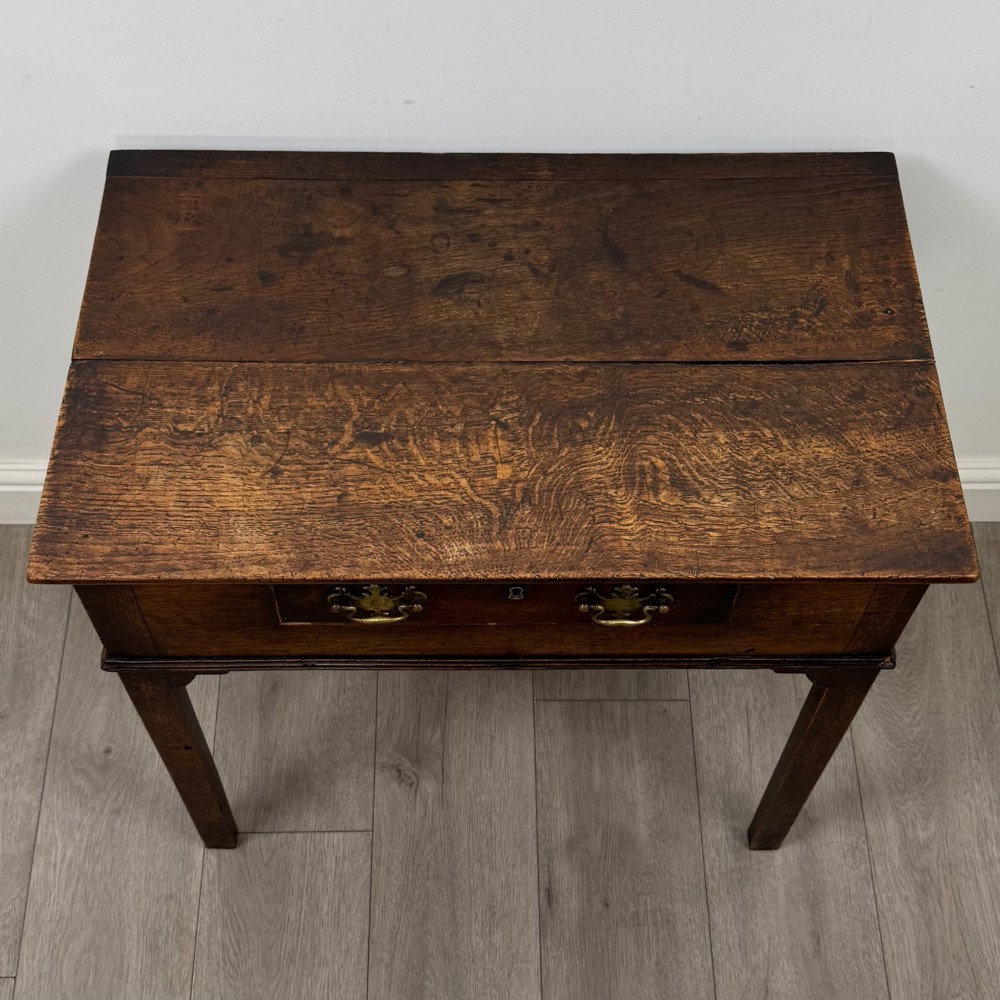 An 18th-century Georgian oak side table featuring a single frieze drawer with brass handles and straight square legs. View IX