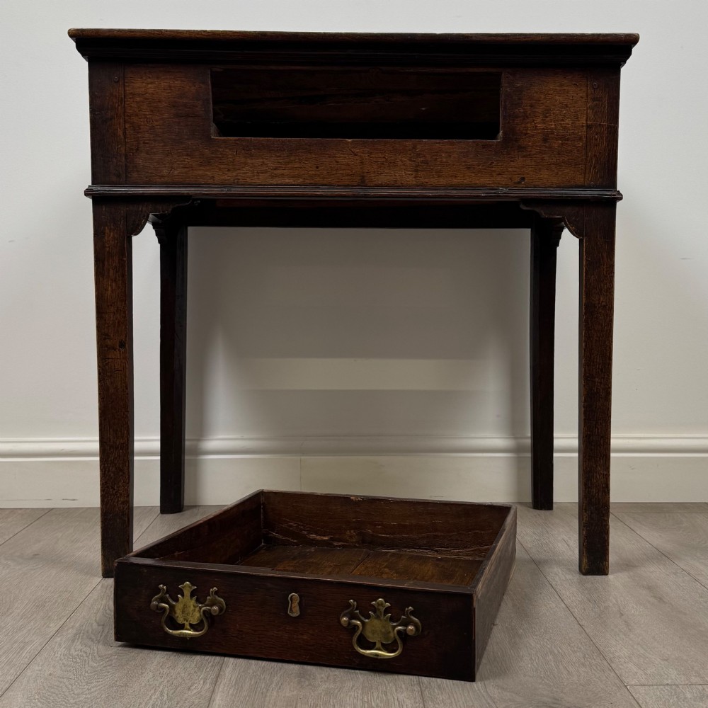 An 18th-century Georgian oak side table featuring a single frieze drawer with brass handles and straight square legs. View X