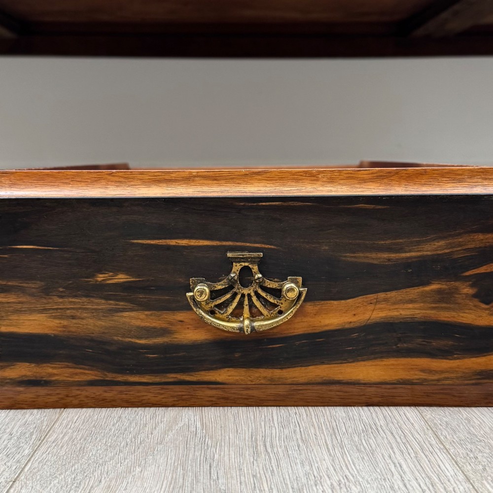 An antique mahogany low sideboard featuring six drawers, a central double cupboard, highly figured veneer panels, brass handles, and turned legs on castors. View XII