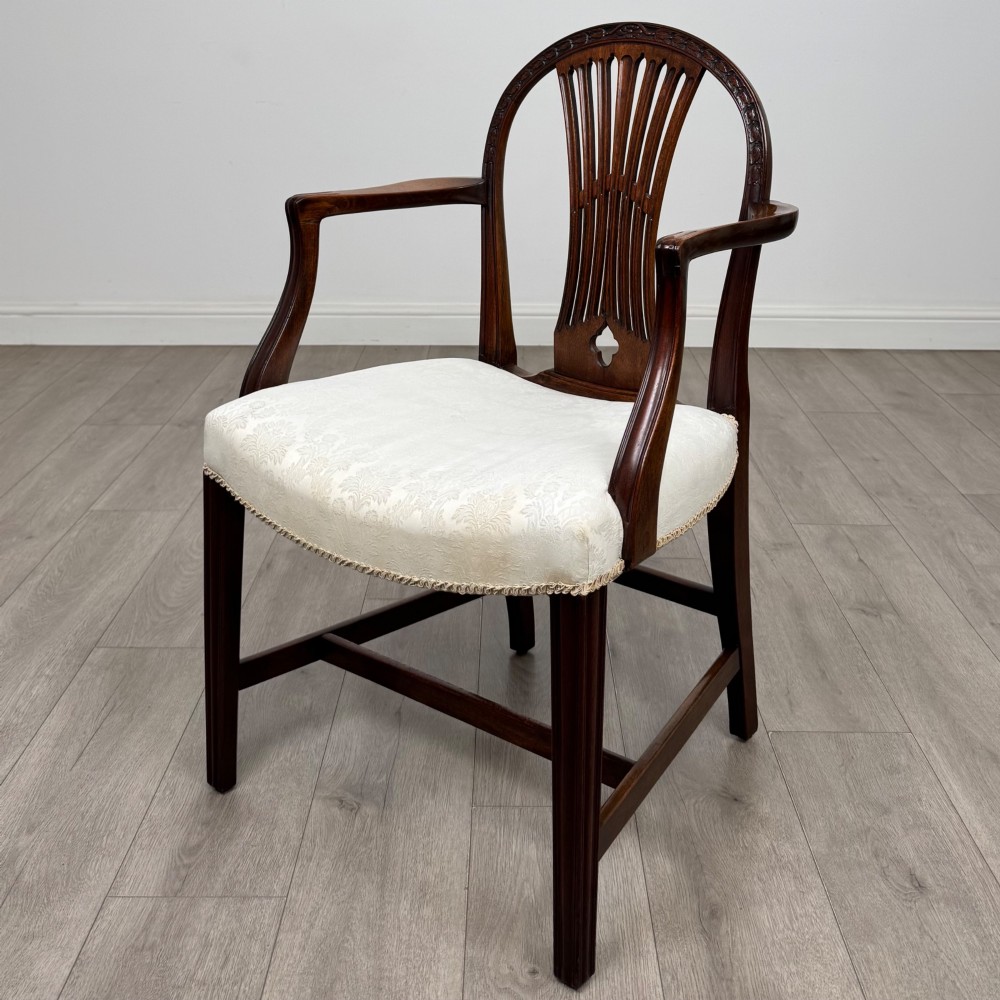 A set of eight 19th-century Hepplewhite style mahogany dining chairs featuring carved openwork back splats, square tapered legs, and light cream upholstered seats. View II