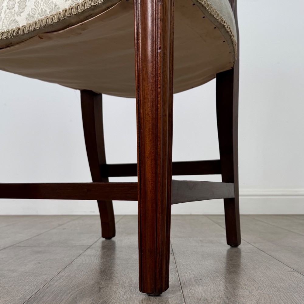 A set of eight 19th-century Hepplewhite style mahogany dining chairs featuring carved openwork back splats, square tapered legs, and light cream upholstered seats. View VII