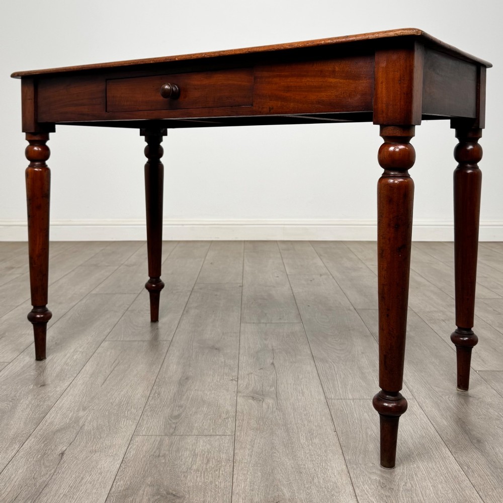 A 19th-century mahogany writing table featuring turned legs and a single frieze drawer with a wooden knob handle. View II