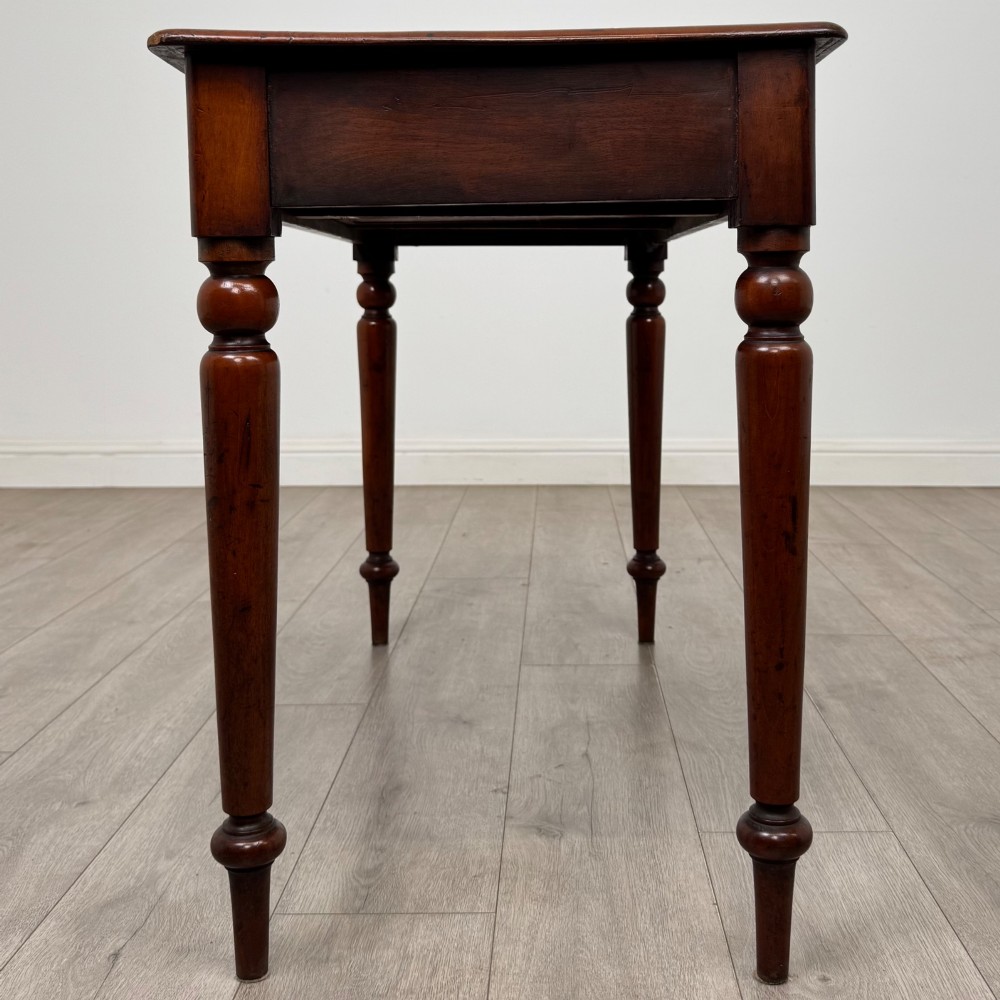 A 19th-century mahogany writing table featuring turned legs and a single frieze drawer with a wooden knob handle. View III
