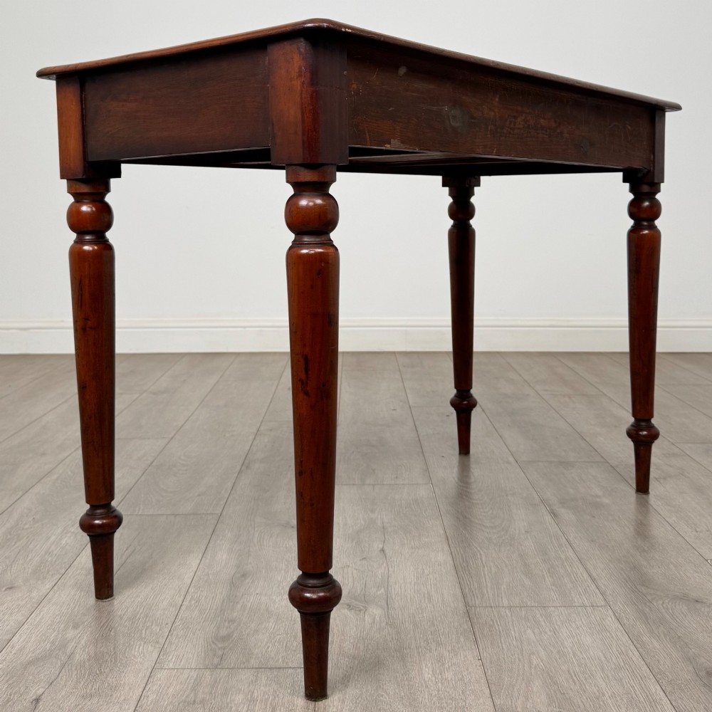 A 19th-century mahogany writing table featuring turned legs and a single frieze drawer with a wooden knob handle. View IV