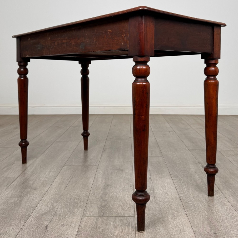 A 19th-century mahogany writing table featuring turned legs and a single frieze drawer with a wooden knob handle. View VI