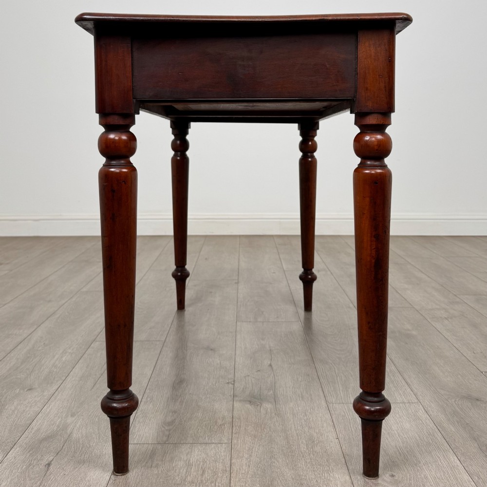 A 19th-century mahogany writing table featuring turned legs and a single frieze drawer with a wooden knob handle. View VII