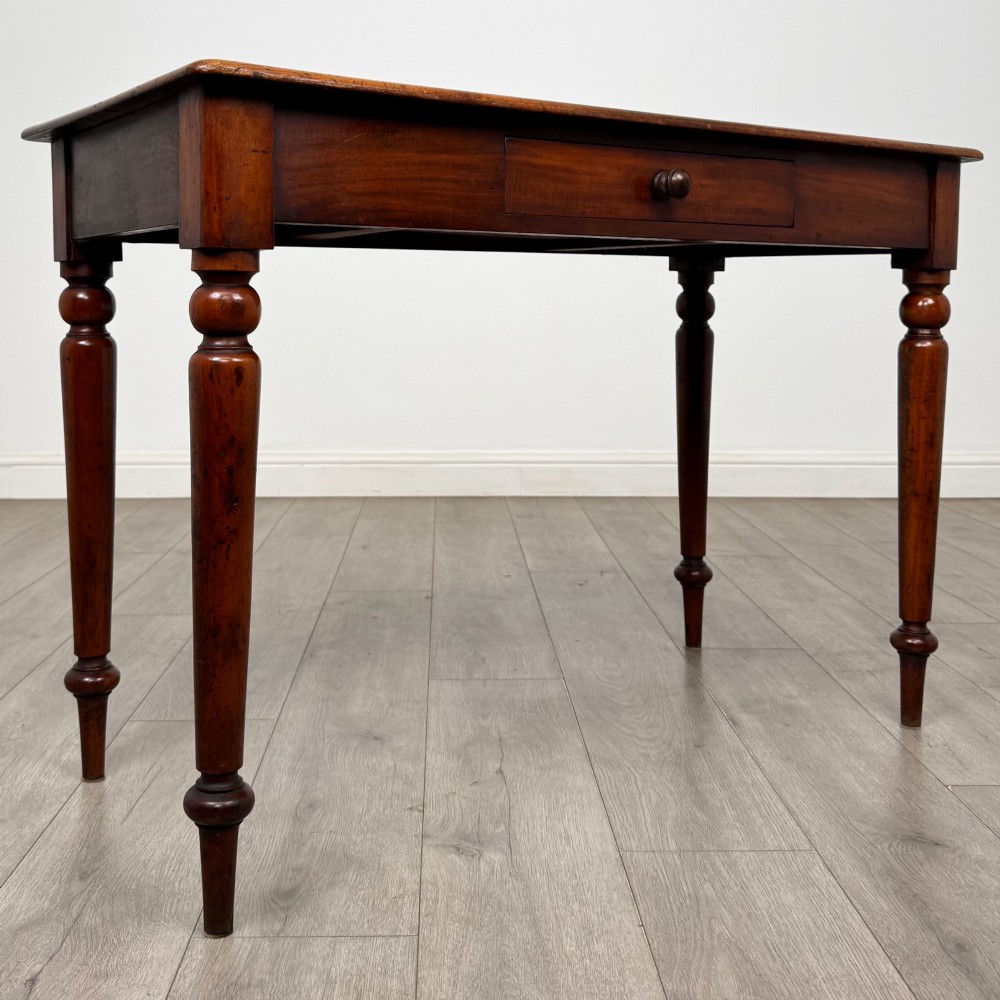A 19th-century mahogany writing table featuring turned legs and a single frieze drawer with a wooden knob handle. View VIII