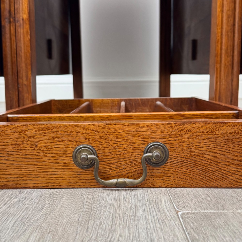 A 20th-century oak drop-leaf table shown with lowered flaps, featuring a single end drawer with a brass drop handle and square legs. View XIII